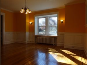 custom raised-panel wainscoting contrasting with rich, warm colors